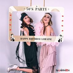 two women dressed up in costumes posing for a photo booth with the caption 50's party