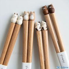 four wooden pencils with animals on them