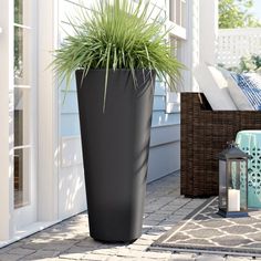 a tall black planter sitting on top of a patio