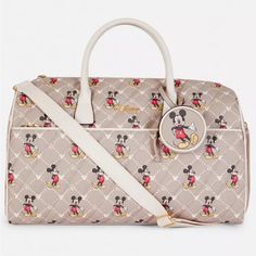 New Limited Edition Disney Weekender Travel Bag Get Ready To Travel. Pack Away Your Weekend, Disney-Style In Our Mickey Mouse Weekender Bag. With A Boxy Structure, It’ll Keep Your Clothing Neatly Arranged, And Has Plenty Of Space For All Essentials Like Shoes And Makeup Bags. Fashioned From A Tan Quilted Fabric With A Monogrammed Mickey Mouse Logo, Its Made With Disney Fans In Mind! Reminds Me Of Louis Vuitton With Mickey Mouse Super Classy. We Also Adore The Mickey Mouse All Over Print, And The Brown Disney Bags For Everyday Use, Disney Style Brown Bag For Everyday Use, Disney Everyday Brown Bags, Disney Travel Bag With Removable Pouch, Disney Travel Bags With Detachable Strap, Trendy Rectangular Bags For Disney Trips, Disney Mickey Mouse Bags For Disney Trips, Disney Mickey Mouse Bags For Everyday Use, Disney Brown Travel Bags