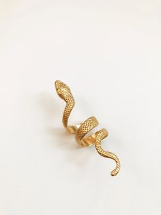 A beautifully engraved 3” snake wrap ring. Historically, serpents and snakes represent fertility or a creative life force. As snakes shed their skin through sloughing, they are symbols of rebirth, transformation, immortality, and healing DETAILS: Brass 3” Long Adjustable Ring Ships with polishing cloth to keep it forever shining. Packaged for gift giving. *Worn with the Nira Ring *Sold individually, not a set. Spiritual Snake Ring As Gift, Handmade Adjustable Spiritual Snake Ring, Spiritual Snake Ring For Gift, Adjustable Snake-shaped Symbolic Rings, Adjustable Snake Symbolic Ring, Adjustable Symbolic Snake Ring, Unique Handmade Snake Ring, Handmade Gold Snake Ring, Handmade Snake Shaped Ring As Gift