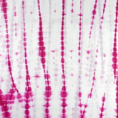 red and white tie - dyed fabric with small circles in the center, on a white background