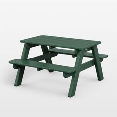 a green picnic table sitting on top of a white floor