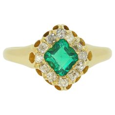 Here we have a fabulous emerald and diamond cluster ring dating back to the Victorian era. A square shaped intense vivid green emerald sits enchantingly at the centre of the face and is framed around the outer edge by a single row of chunky old mine cut diamonds. Each diamond is accompanied by a pierced opening just below before the piece is finished with a rich 14ct yellow gold band. Condition: Used (Very Good) Weight: 5.0 grams Band Width: 2.5mm Ring Size: S (60) Face Dimensions: 12.5mm x 10mm Emerald Weight: Approx. 1.05ct Total Diamond Weight: Approx. 0.24ct Hallmarked: 18ct, London, 1869 Maker's Mark: DNL Period: Victorian Box: Plain Gift Box The Victorian Era, La Face, Diamond Cluster Ring, Green Emerald, Diamond Cluster, Emerald Diamond, Cluster Ring, Victorian Era, Makers Mark