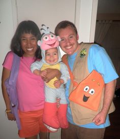 two adults and a child are posing for a photo with cartoon characters on their shirts