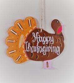 a happy thanksgiving turkey ornament hanging on a wall