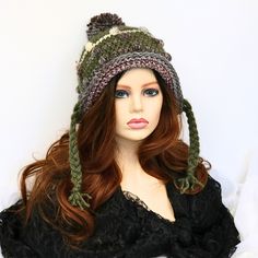 Comfortable and fun to wear, this soft funky snow hat has braids for ties. The top has a matching pom pom and the body has textural bumps worked in, giving a rustic edge to your look. You can roll back the brim to give a different look, or leave a bit of a brim. I've shaped it to sit secure on your head and cover your ears so you can wear it untied, but the braids are still long enough to tie if you want to. Great for skiing, sledding, going to an outdoor market, running your errands, or just sh Adjustable Fall Hat With Ear Flaps, Adjustable Ear Flap Hat For Fall, Adjustable Ear Flaps Hat For Fall, Adjustable Cap For Cold Weather, Casual Adjustable Mini Hats For Winter, Multicolor Beanie Mini Hat For Winter, Fun Brimmed Winter Hat, Multicolor Mini Beanie Hats For Winter, Adjustable Winter Crochet Beanie Hat