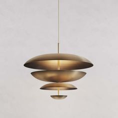 three circular lights hanging from a ceiling fixture