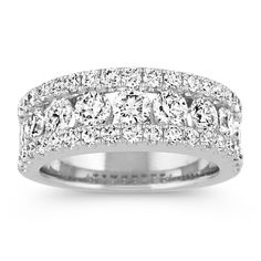 This classic wedding band features 47 pavé and channel-set round diamonds at approximately 2.20 carats total weight. Each magnificent gemstone has been hand-matched for exceptional beauty and sparkle. The quality 14 karat white gold setting measures an elegant 7.5mm at the center. 3 Row Diamond Ring, Marquise Rings, Ring Wraps, Round Diamond Band, Hand Rings, Diamond Anniversary Bands, Celtic Wedding Rings, Minimalist Engagement Ring, Diamond Fashion Rings