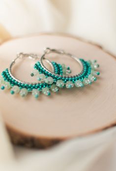 This is a handmade seed bead hoop earring. Used with high quality materials, on a high quality zinc alloy hoop. This item contains Dyed Aventurine gemstone beads. Aventurine is often associated with being the "Stone of opportunity. It is known to be the stone of perseverance. A great accessory at add to any outfit whether it is a casual day or a fancy outing. It is also August'd birthstone. Size: (40) mm Pleased be advised that these earrings are of high quality however it is advised that all it Handmade Green Beaded Hoop Earrings, Green Beaded Hoop Earrings For Gift, Gift Dangle Hoop Earrings With Spacer Beads, Nickel-free Metal Hoop Beaded Earrings, Nickel-free Small Hoop Metal Beaded Earrings, Hoop Beaded Earrings With Spacer Beads, Metal Hoop Beaded Earrings As Gift, Hoop Earrings With Dangling Round Beads As Gift, Metal Beaded Hoop Earrings As A Gift