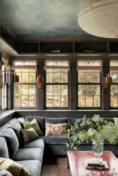 a living room filled with furniture and lots of windows