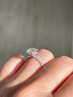 a woman's hand with a diamond ring on it