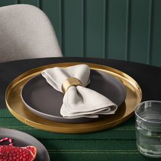 a table with plates and napkins on top of it next to a glass vase