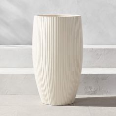 a large white vase sitting on top of a floor