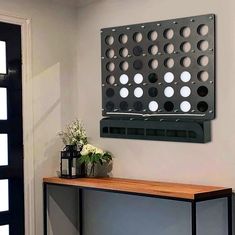 a black and white wall hanging over a wooden table