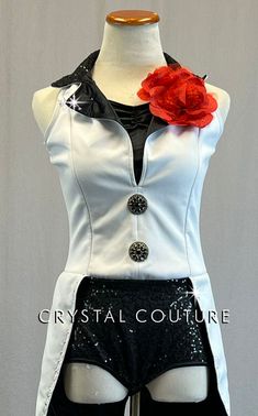 a mannequin dressed in black and white with a red rose on it's lapel