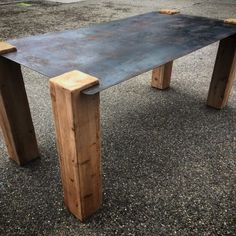 a wooden table sitting on top of a parking lot