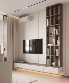 a living room filled with furniture and a flat screen tv on top of a wooden shelf