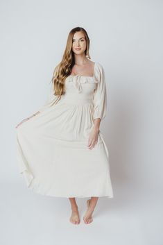 The Juliet Midi Dress is an elegant, ultra-flattering gown that's perfect for any occasion. We just love a 3/4 length sleeve, and the Juliet delivers with a loose, elastic-cuffed sleeves, plus a square neckline and smocked bodice for maximum comfort. Pair with slides for a more relaxed look, or dress it up with neutral heels! FIT: Runs true to size. MATERIAL: GARMENT DETAILS: A-line midi dress with square neckline and 3/4 length sleeves with elasticized cuffs. Features a smocked bodice, accent r Chic 3/4 Sleeve Wedding Dress, Chic Wedding Dress With 3/4 Sleeves, Elegant Summer Dress With 3/4 Sleeves, Elegant Half Sleeve Maxi Dress For Fall, Spring Wedding Maxi Dress With 3/4 Sleeves, Fall Flowy Half Sleeve Dresses, Chic Flowy Maxi Dress With 3/4 Sleeves, Elegant Spring Midi Dress With 3/4 Sleeves, Flowy Half Sleeve Dress For Fall