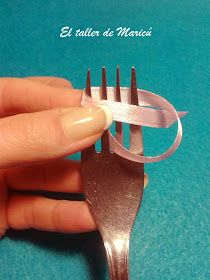 a person is holding a fork that has been cut into smaller pieces with silver strips