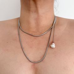 This elegant extra-long necklace is perfect for any occasion. Crafted from 100% stainless steel, it features a high-polish finish and no tarnish. The necklace measures 41.5" long with an additional 2" extension for a versatile fit. A single faux shell pearl is delicately placed on a 9.5" chain on the side, adding a touch of uniqueness and sophistication.  Swap out the faux pearl for fresh water pearl, or your favprite pendant  for an additional $10.  You'll want to wear this beautiful necklace w Silver Lariat Necklace In Stainless Steel, Silver Stainless Steel Lariat Necklace, Silver Metal Chain Necklace For Mother's Day, Elegant Stainless Steel Snake Chain Necklaces, Elegant Stainless Steel Snake Chain Necklace, Minimalist Silver Lariat Necklace With Pearl Chain, Silver Long Necklace With Pearl Chain As Gift, Silver Long Necklace With Pearl Chain For Gift, Silver Stainless Steel Necklace With Pearl Chain