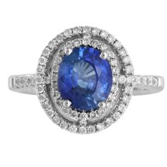 This stunning 18K White Gold Cocktail Ring features a vibrant 2.00 Ctw Oval Blue Sapphire at the center, surrounded by a sparkling diamond halo and side accents. With a total carat weight of 2.46 Ctw, this bold yet elegant piece is perfect for making a statement at any special occasion. Weight: 7.2g Head: 14 mm Shank: 3.2 mm Ring size: 6.5 Sapphire: 2 Ctw Diamonds: 57 x 0.0067Ctw = 0.38Ctw 8 x 0.08Ctw = 0.80 Color And Clarity: G-H/SI1 Total Carat Weight: 2.46Ctw For more of our jewelry products, please visit our shop 777jewelry Free shipping on all orders within the USA. International shipping available. We only sell real gold jewelry. We do not sell gold plated or gold filled jewelry. We offer a 30 day money back guaranteed return on all orders. Our goal is to make every customer satisfie Oval Blue Diamond Ring With Pave Setting, Blue Oval Gia Certified Halo Ring, Blue Diamond Ring With Pave Setting, Blue Cluster Diamond Ring With Halo Setting, Blue Sapphire Ring With Halo Cluster Setting, Blue Brilliant Cut Cubic Zirconia Cluster Ring, Blue Cubic Zirconia Cluster Ring With Brilliant Cut, Formal Blue Halo Ring With Diamond Accents, Blue Diamond Ring With Halo In Fine Jewelry Style