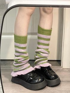 These knitted leg warmers feature a striking color-blocked stripe pattern, accented with charming ruffle edges at the hem. The design exudes a playful yet sophisticated vibe, perfect for adding a touch of whimsy to any outfit.  Please note, the price includes one pair of leg warmers only. Trendy Ribbed Leg Warmers For Spring, Casual Striped Leg Warmers For Winter, Casual Striped Leg Warmers For Fall, Casual Green Leg Warmers For Fall, Trendy Knitted Leg Warmers For Spring, Trendy Spring Leg Warmers One Size, Knitted Leg Warmers For Spring, Spring Knit Leg Warmers, Trendy One-size Leg Warmers For Spring