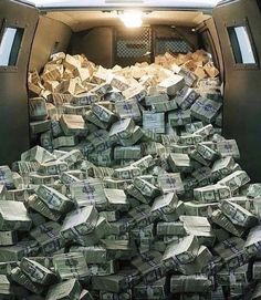 the back of a truck filled with stacks of cash