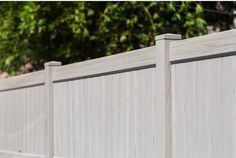 a close up view of a white picket fence