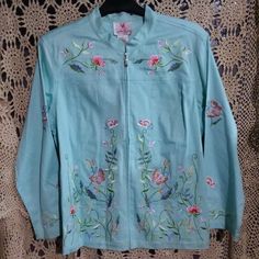 Quacker Factory Floral Embroidered Zip Front Jeans Jacket Size 1x Teal With Embroidery 97% Cotton/ 3% Spandex Gemstone Zipper Closure 25.5" Pit To Pit 27" Long 23.75" Sleeves Beautiful Needlework On This Jacket Excellent New With Tag Condition Light Blue Cotton Outerwear For Spring, Blue Embroidered Outerwear For Spring, Denim Jacket Embroidery, Brown Denim Jacket, Vintage Jeans Style, Bedazzled Jeans, Green Denim Jacket, Embellished Denim Jacket, White Jean Jacket