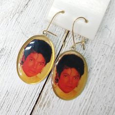 NOS vintage Michael Jackson enamel earrings on card gold tone metal dangle earrings face picture measurements: 1" x .5" great/excellent condition- new old stock on original store tag, general age and wear from storage, please note all photos. We gladly accept  exchanges, and cancellations Contact us within: 3 days of delivery Ship items back within: 7 days of delivery Request a cancellation within: 1 hour of purchase The following items can't be returned or exchanged. Because of the nature of th Vintage Michael Jackson, Face Pictures, Enamel Earrings, Small Jewelry, Gold Tone Metal, Michael Jackson, Photo Gifts, Jewelry Earrings Dangle, Dangle Drop Earrings