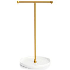 a white plate with a gold handle on it and a metal bar in the middle