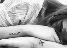 two girls with tattoos on their arms and one has the word what? written on her arm