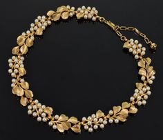 Trifari jewelry is often collected by vintage jewelry enthusiasts. The Trifari Leaf Faux Pearl Necklace is a classic piece  that would look great with a variety of outfits.  It is a timeless piece of jewelry  that is sure to be cherished for years to come. Gorgeous gold plated textured leaf link necklace with faux pearl clusters from 1960's by  Alfred Phillipe for Trifari. The necklace is adjustable with extender chain up to 16 1/2" long. The width of the necklace is 17 mm max. The hook closure Jewelry Creator, Necklace C, Trifari Jewelry, Pearl Cluster, Faux Pearl Necklace, Gold Tone Necklace, Adjustable Necklace, Glass Bead Necklace, Chain Link Necklace