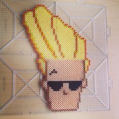 a pixelated image of a man with sunglasses on his head and hair in the shape of a fireball