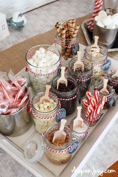 a tray filled with lots of food on top of a wooden table covered in candy