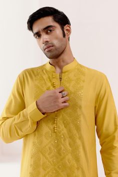 Mustard short kurta with tonal dori embroidery. Paired with a slim fit pant.
Components: 2
Pattern: Embroidery
Type Of Work: Dori, Floral
Neckline: Stand Collar
Sleeve Type: Full Sleeves
Fabric: Cotton Silk Blend
Color: Yellow
Other Details: 
Model height: 5ft 11inches, wearing size M
Occasion: Sangeet - Aza Fashions Traditional Embroidered Semi-formal Sets, Festive Embroidered Traditional Wear For Semi-formal Occasions, Semi-formal Embroidered Traditional Wear, Embroidered Semi-formal Traditional Wear For Diwali, Festive Cotton Sets With Tonal Embroidery, Festive Tonal Embroidery Sets For Eid, Festive Sets With Tonal Embroidery For Eid, Traditional Chikankari Embroidered Kurta For Semi-formal Occasions, Semi-formal Traditional Wear With Resham Embroidery