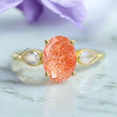 Sunstone promise ring for her, Unique oval cut sunstone engagement ring, Orange Gemstone Ring Art Deco Women Handmade Jewelry, Promise Gifts This exquisite orange gemstone ring, inspired by Art Deco design, represents a stunning example of handmade jewelry for women seeking promise gifts.A distinctive oval-cut sunstone engagement ring epitomizes individuality and grace. Gemstone Details :- - Gemstone: Sunstone  - Stone Type: Lab Created - Shape: Oval Cut - Size: 8x6 MM - Color: Oval  - Luster: E Orange Topaz Ring With Center Stone For Gift, Orange Topaz Ring With Center Stone As Gift, Oval Orange Sapphire Ring For Gift, Oval Orange Sapphire Ring As Gift, Orange Oval Sapphire Gemstone Ring, Orange Rings With Accent Stones For Gift, Orange Oval Sapphire Ring, Oval Orange Rings With Accent Stones, Oval Orange Ring With Center Stone