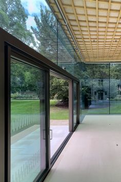 Glass entrance doors set within the glass facade at Rhodes House Stanton Williams, Glass Facade, Garden Pavilion, Storage Tanks, Glass Facades, Glass Doors, The Glass, Heating Systems, Rhodes