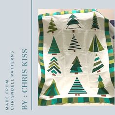 a quilted christmas tree design on a white background with green and blue stripes,