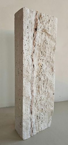 a stone block sitting on top of a white floor