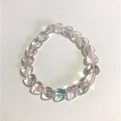 a bracelet made out of glass beads on a white surface