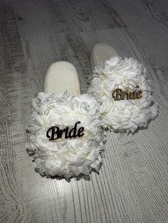 the bride and groom slippers have flowers on them