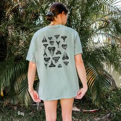 This Respect the Locals Shark Tooth Shirt is printed on a Comfort Colors tee. These tee's are made with 100% ring-spun cotton, giving them a soft and relaxed fit. Perfect for a beach day hunting sharks teeth! Details - made with 100% ring-spun cotton - soft-washed, garment-dyed fabric for soft color and texture - double-needle stitching throughout tee for durability SHIPPING Production time can take 2-7 business days, although the average time is 2.9 days Shipping times in the US is 2-5 business days. *shipping to Alaska, Hawaii, Puerto Rico and unincorporated territories of the US can take an additional 7-12 business days. RETURNS Each shirt is Print-on-Demand, meaning it is not created until you order. Therefore, returns and exchanges are not accepted unless a product arrives damaged. If Respect The Locals Shark, Beachy Clothes, Ocean Outfits, Respect The Locals, Shark Conservation, Sharks Teeth, Vsco Aesthetic, Shark Lover, Beach Tee