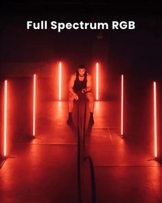 a man sitting in the middle of a room surrounded by red lights and text that reads full spectum rgb