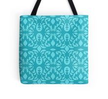 a blue tote bag with an ornate design