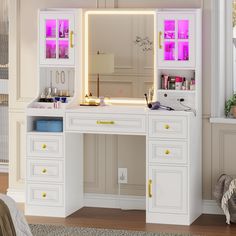 a white vanity with lighted mirror and drawers