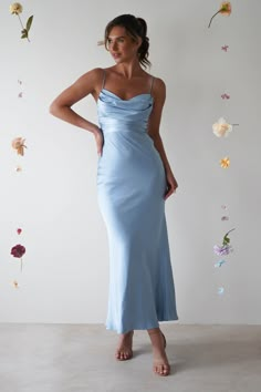 a woman in a blue dress posing for the camera