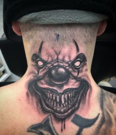 a man with a scary clown face tattoo on his back neck and upper part of the neck