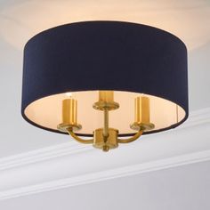 a chandelier hanging from the ceiling in a room with white walls and trimmings